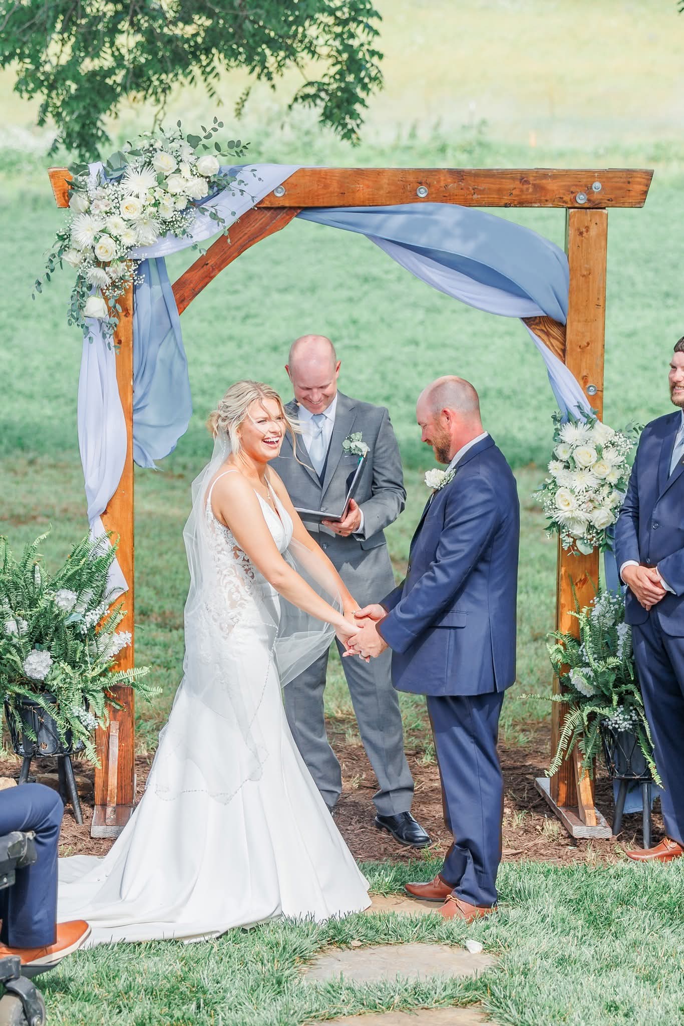 Bride and groom holding hands at alter