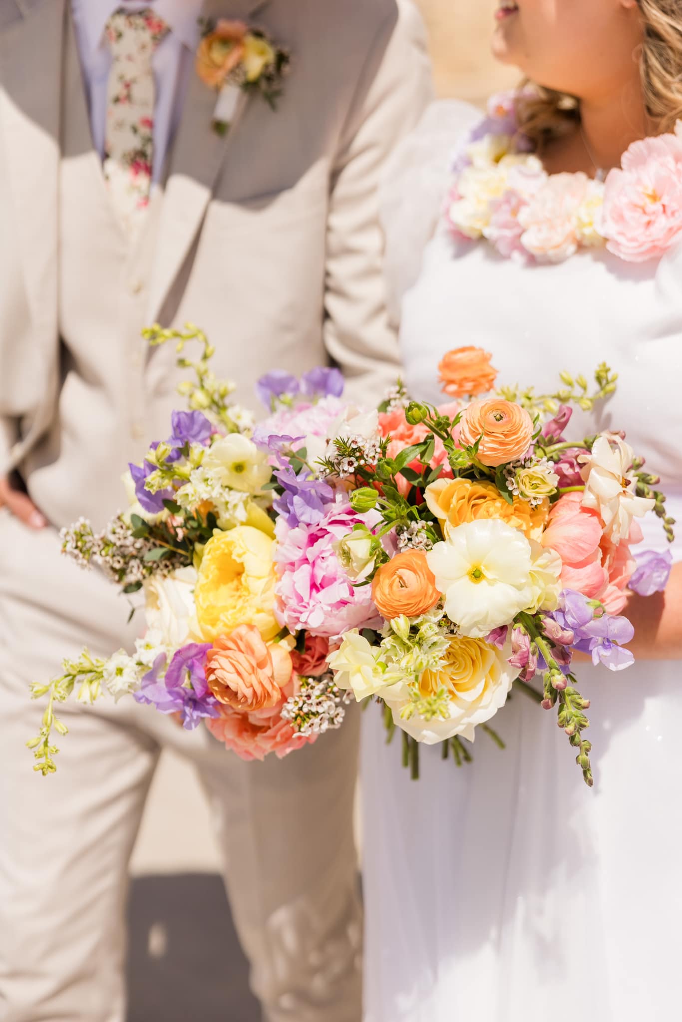 Bride and groom holding flower bouquet