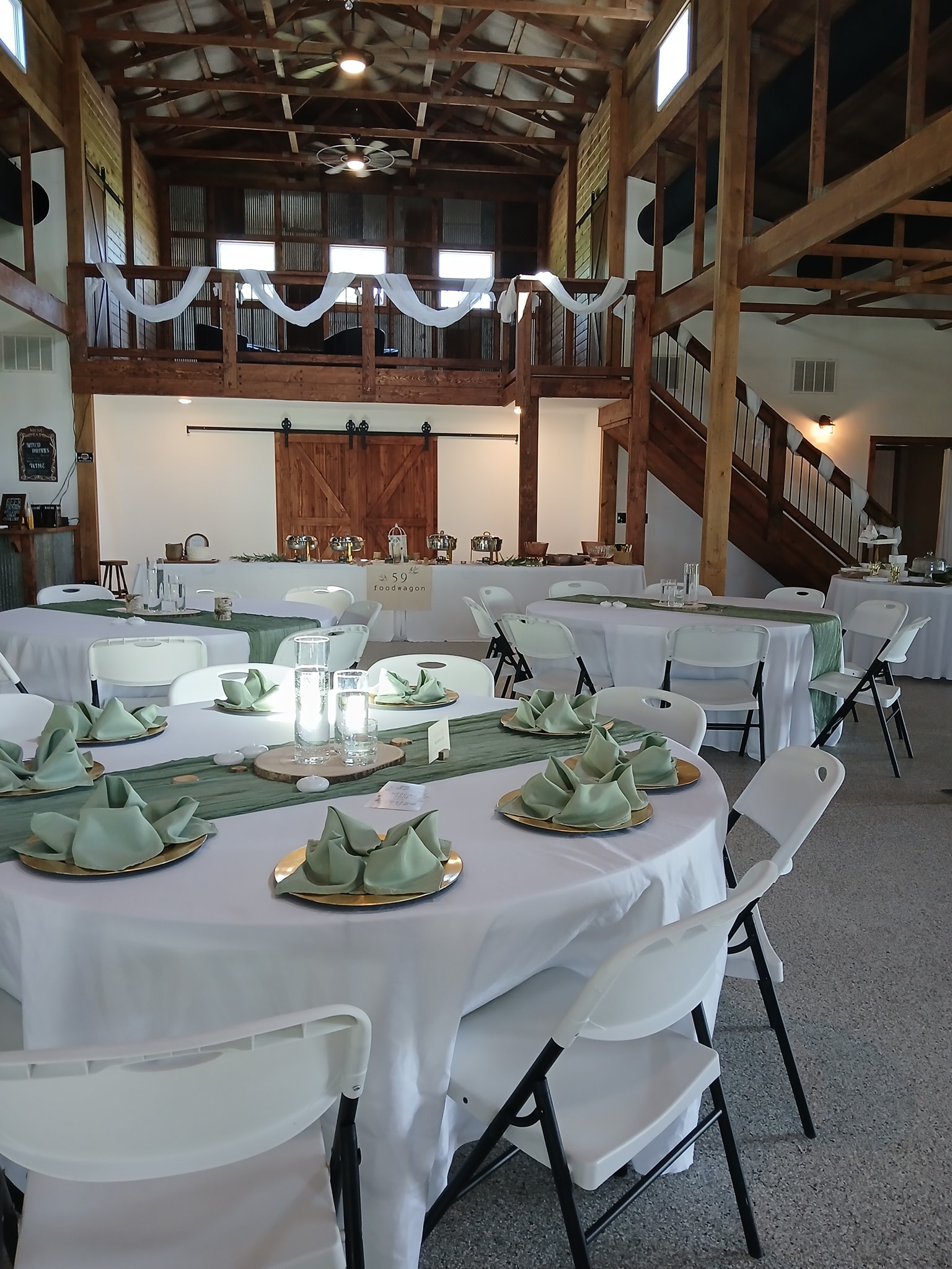 White round tables with green napkin set up