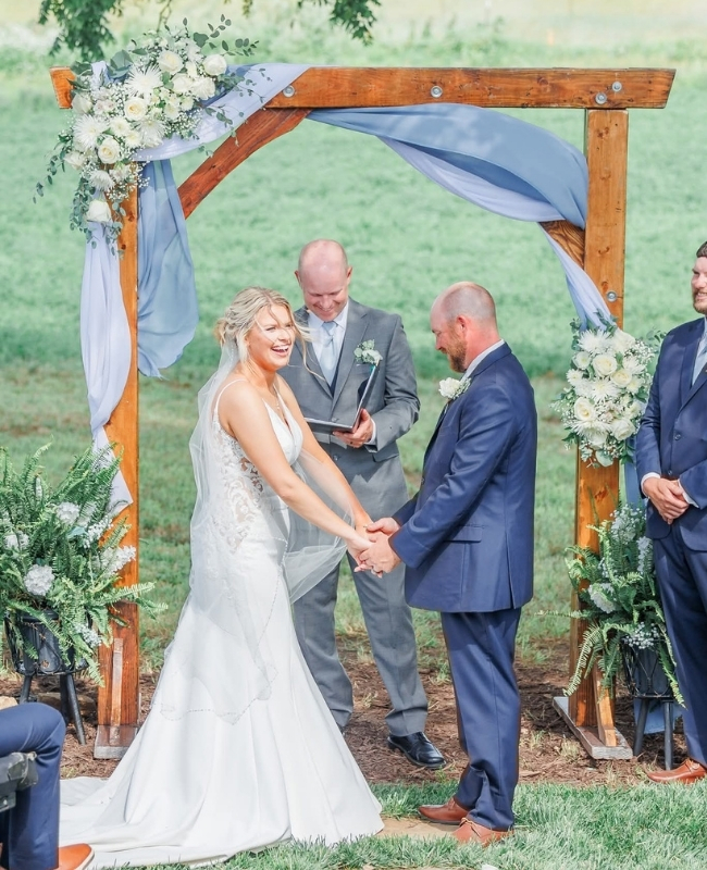 Bride and groom standing at alter holding hands